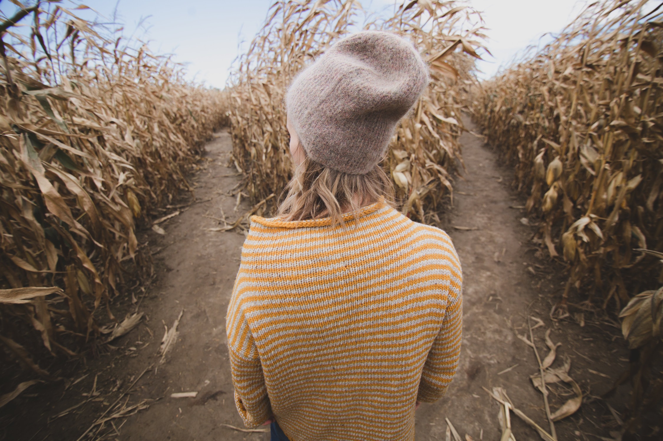 A woman standing before two paths trying to make a decision