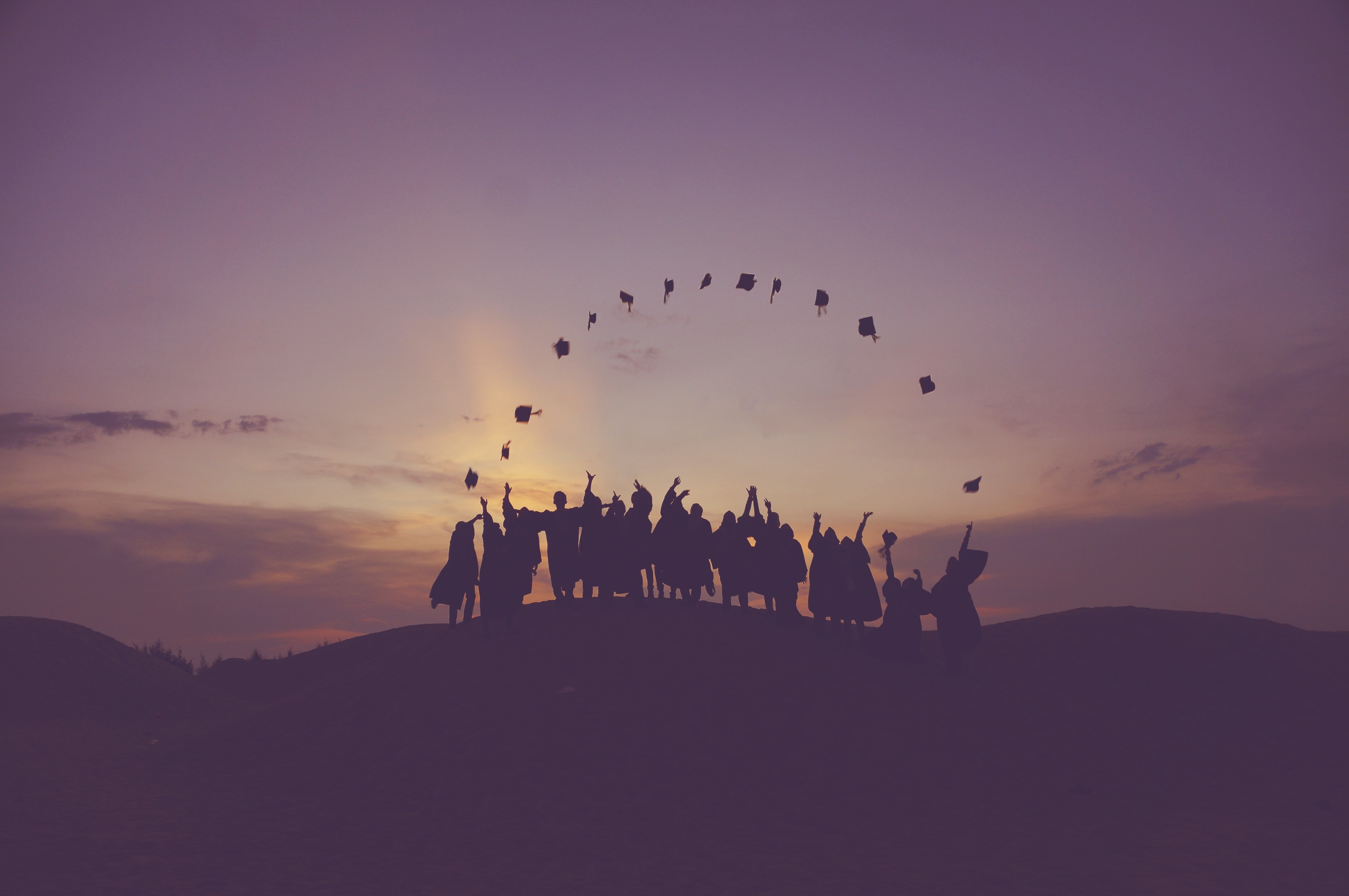 Graduates throwing their caps into the air